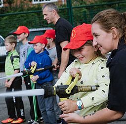 Image of children learning Fire Rescue skills