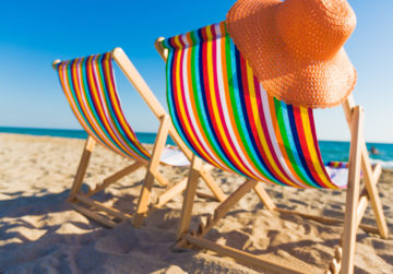 Deckchairs on sandy beach