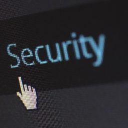 Hand-shaped mouse pointer points at the word Security on a computer screen